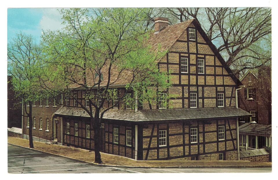 A vintage postcard of the Single Brother's House in Old Salem Village.